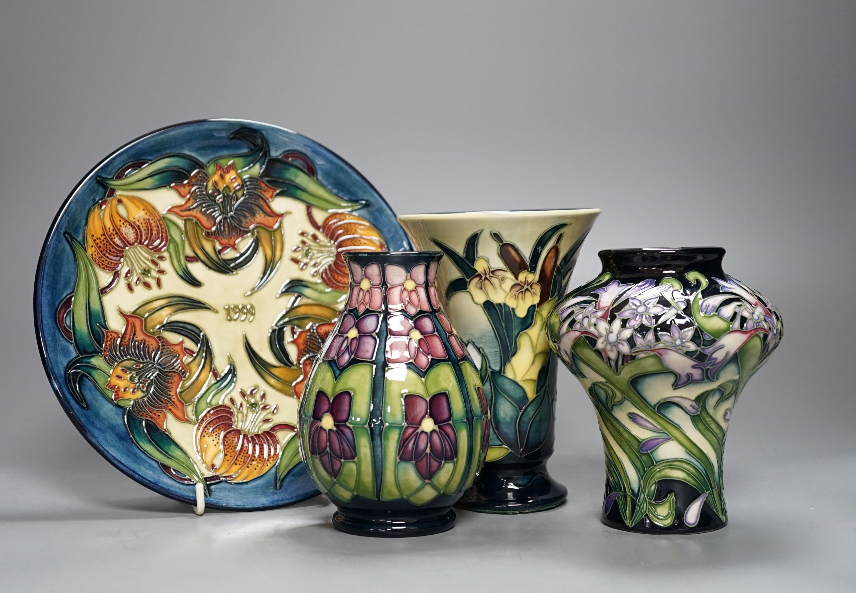 Three modern Moorcroft vases, tallest 15.5 cm and a plate 22 cm